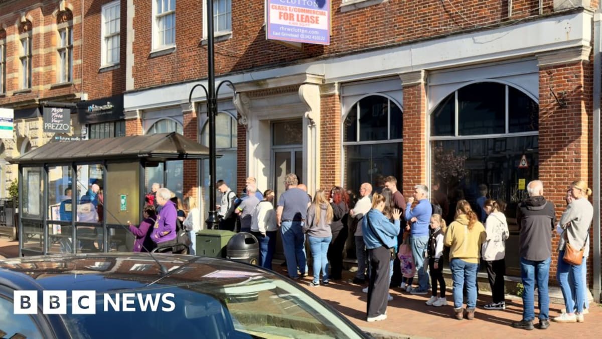 Music fans standing in line outside independent record shop early morning for Record Store Day