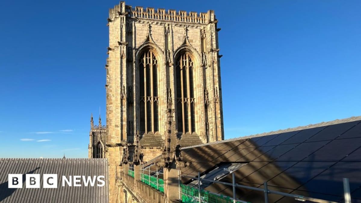 Solar panels installed on the ancient stone roof of historic York Minster cathedral