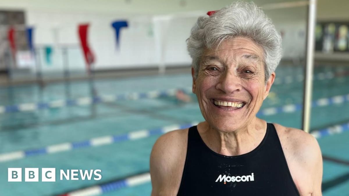 Jane Asher, 95-year-old world record swimmer from south London, smiling in swimming attire