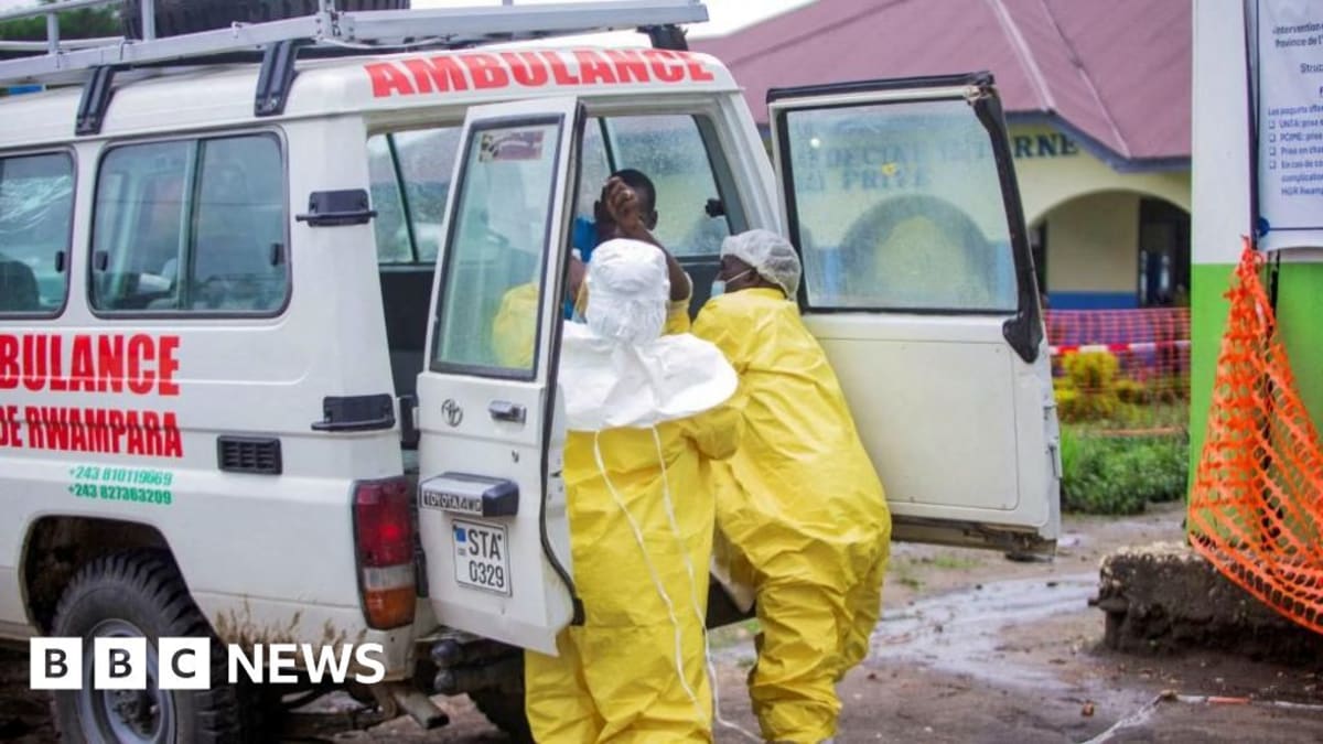 Medical researchers in protective equipment working in laboratory setting conducting Ebola treatment research