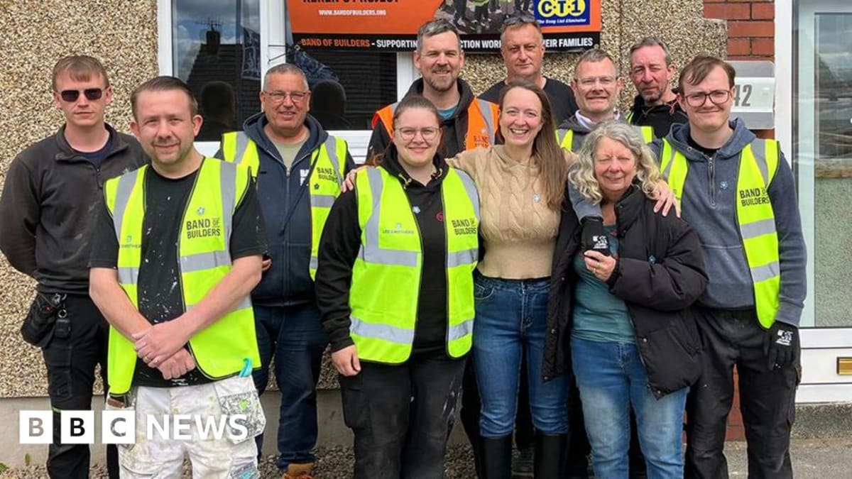 Vicky Maddox standing with her mother and construction volunteers outside newly renovated Burnley home