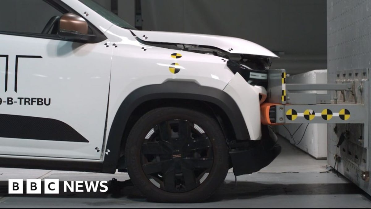White electric car in safety testing laboratory after low speed collision demonstration