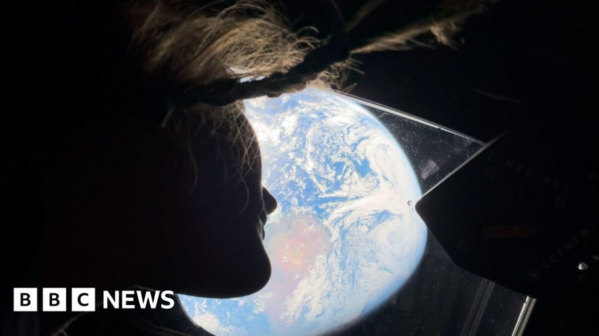Earth appearing upside down from space showing Sahara Desert and auroras glowing