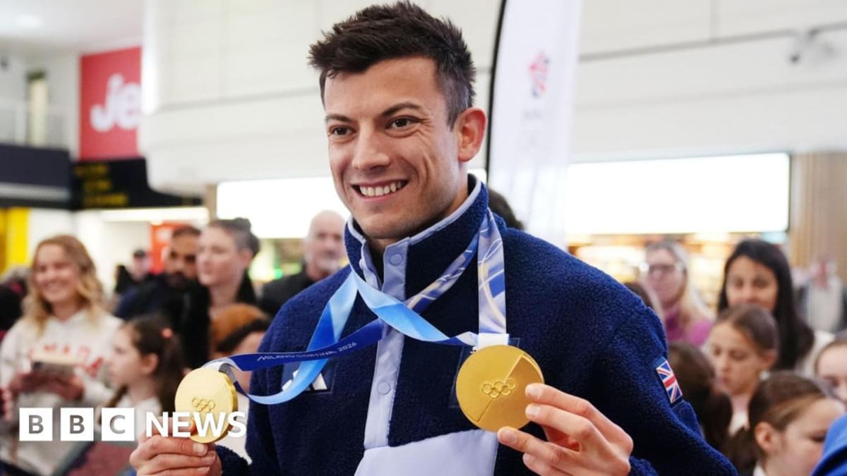 Olympic skeleton racer Matt Weston in Team GB uniform celebrating gold medal victory