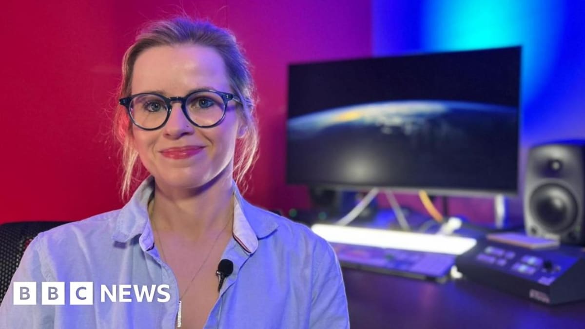 Dr. Christina Mackaill in medical scrubs standing beside space medicine equipment in Glasgow hospital