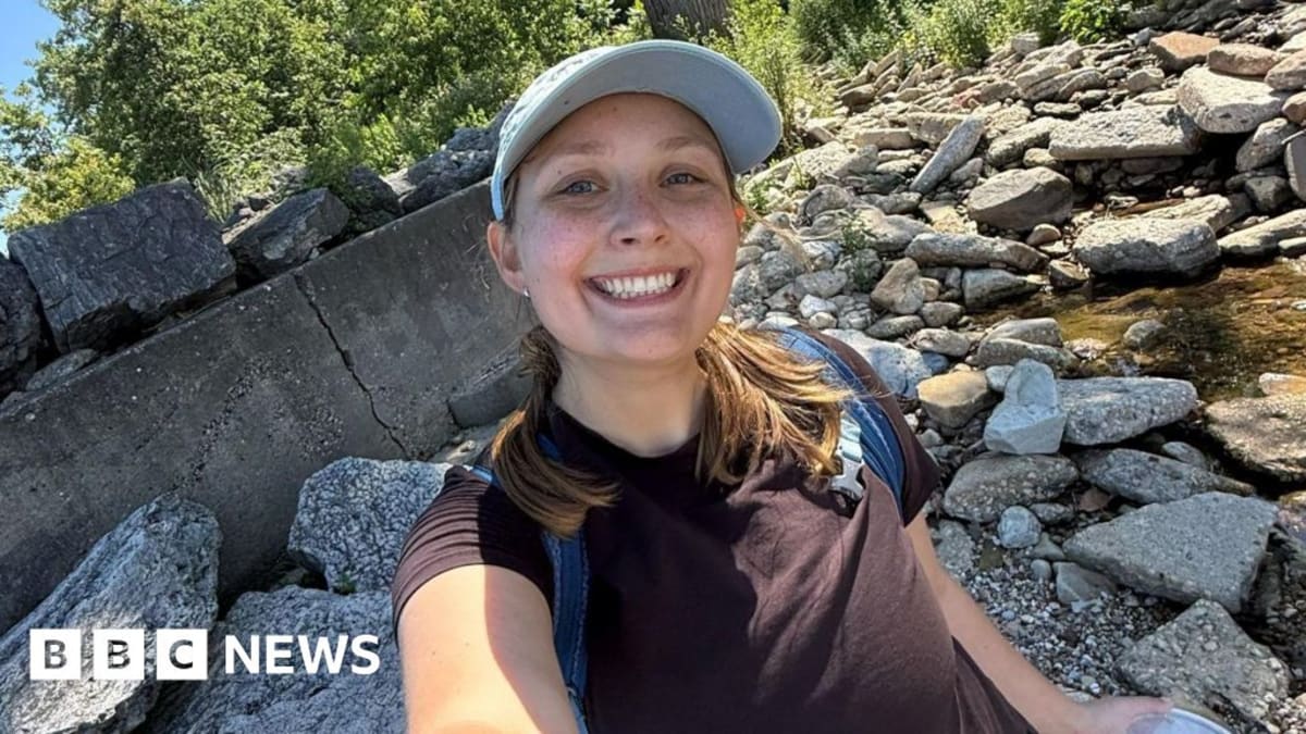Young woman using smartphone app to identify bird species outdoors in nature