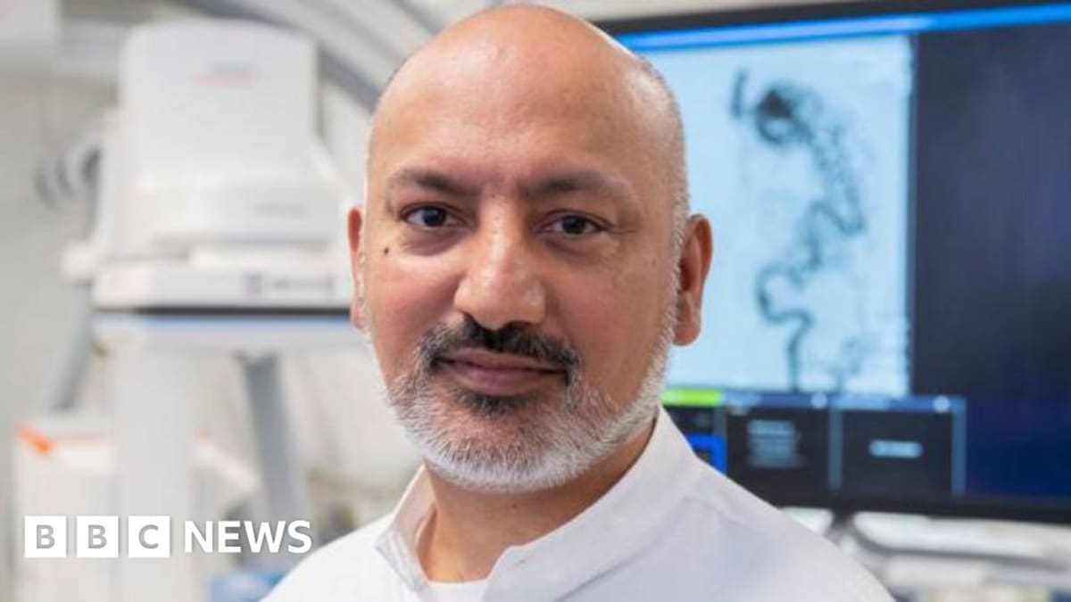 Zehair Ayub smiling with Dr. Fathallah Islim reviewing brain scans at Leeds Teaching Hospitals