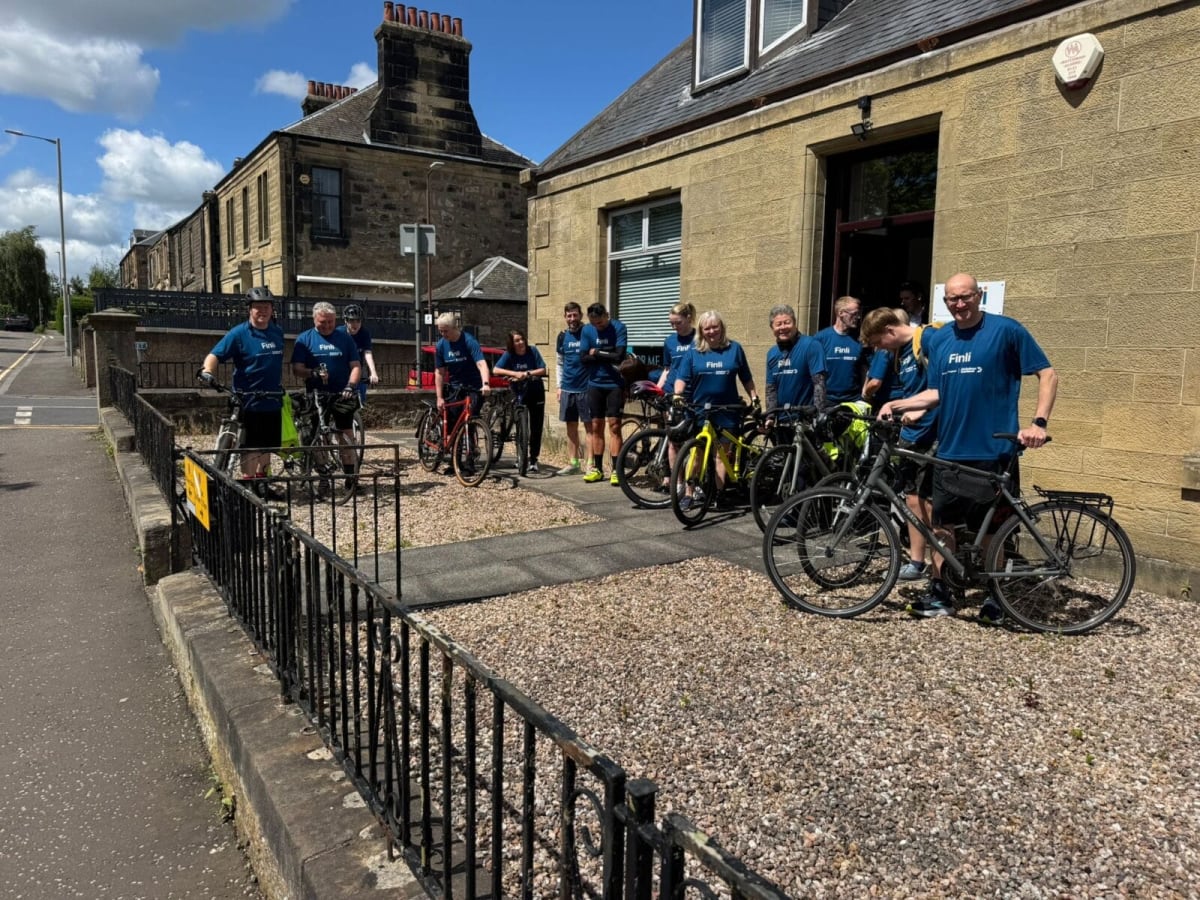 Financial planning team members walking and cycling outdoors for Alzheimer's charity relay challenge
