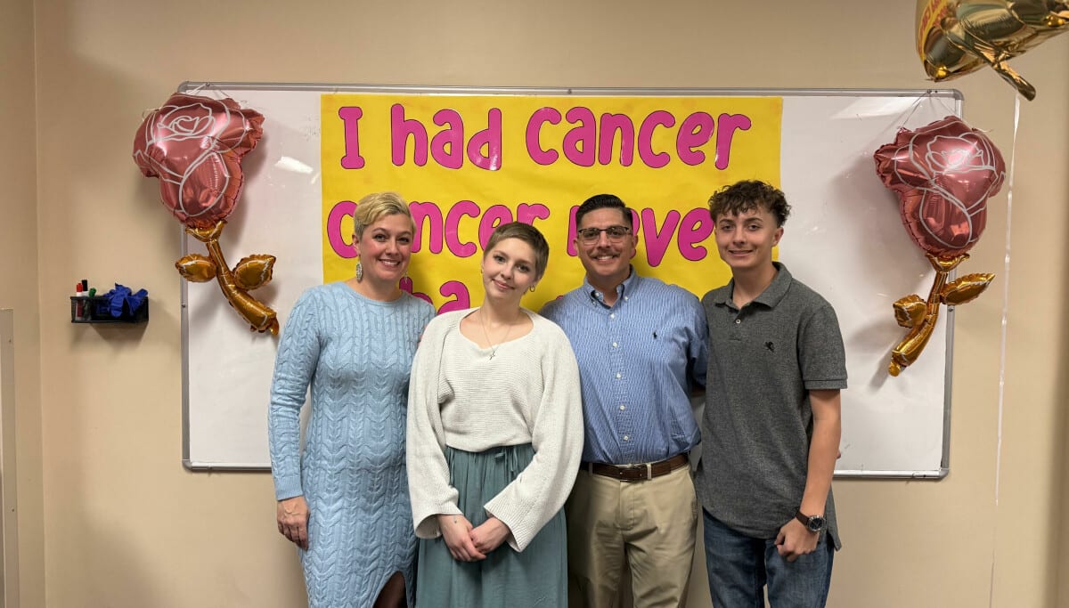 Isabella Solis with her parents and brother smiling at Presbyterian Hospital in Albuquerque