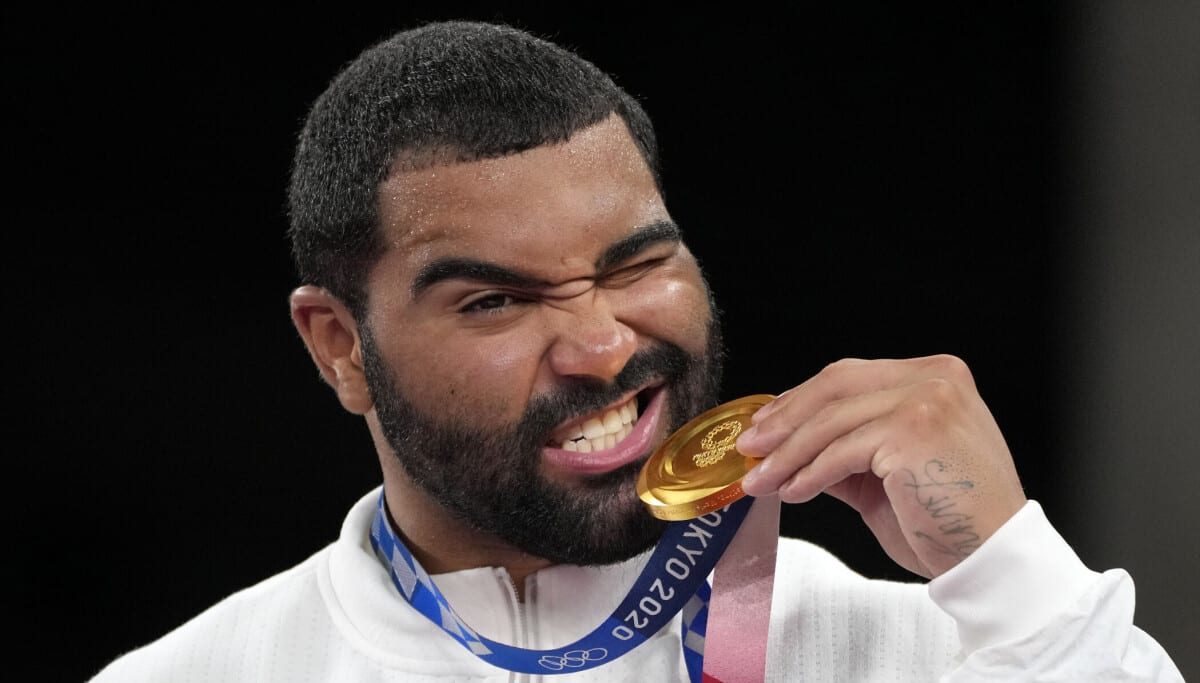 Gable Steveson holds his Olympic gold medal after winning freestyle wrestling in Tokyo