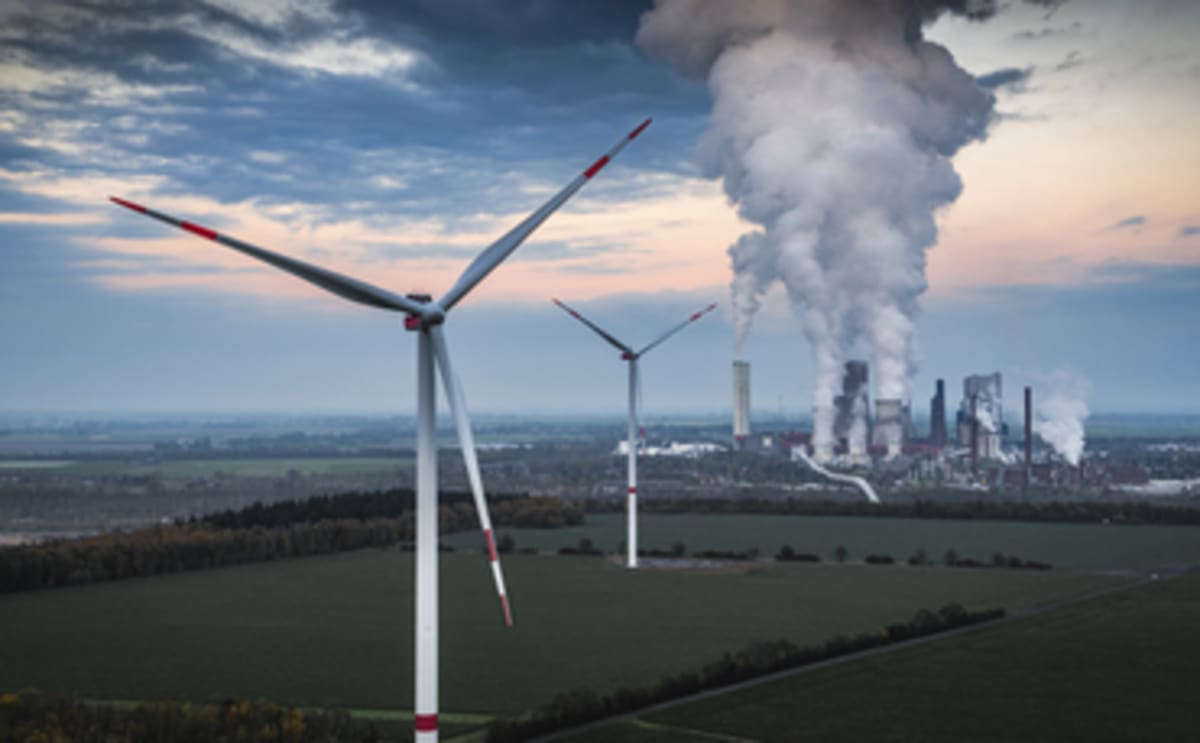 Solar panels and wind turbines generating clean renewable energy under bright blue sky