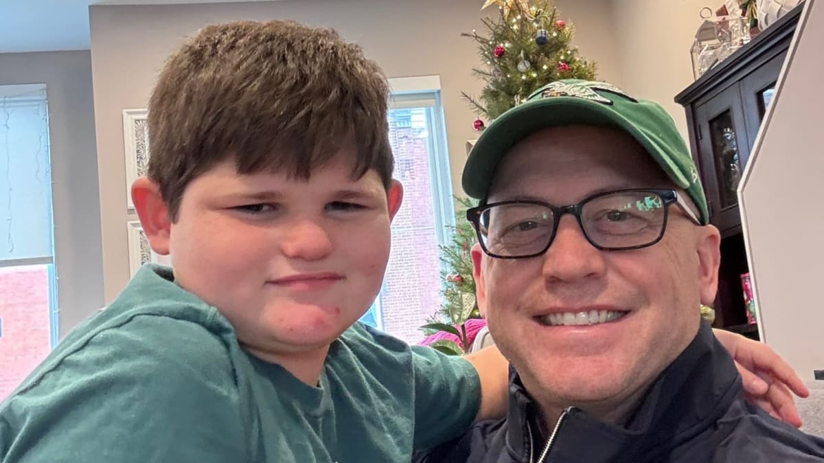 Emergency room physician Dr. Joseph D'Orazio smiling with his young son Gabe outdoors