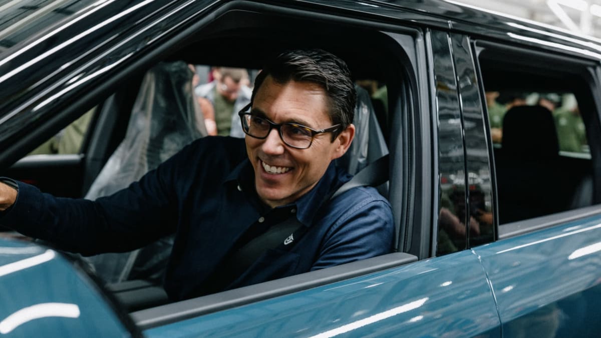 Rivian CEO RJ Scaringe driving first customer-ready blue R2 electric SUV off Illinois assembly line