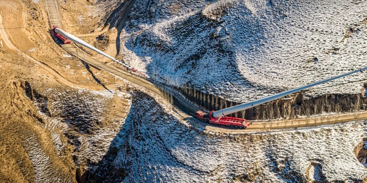 Wind turbine being transported across mountainous terrain in China's Loess Plateau region