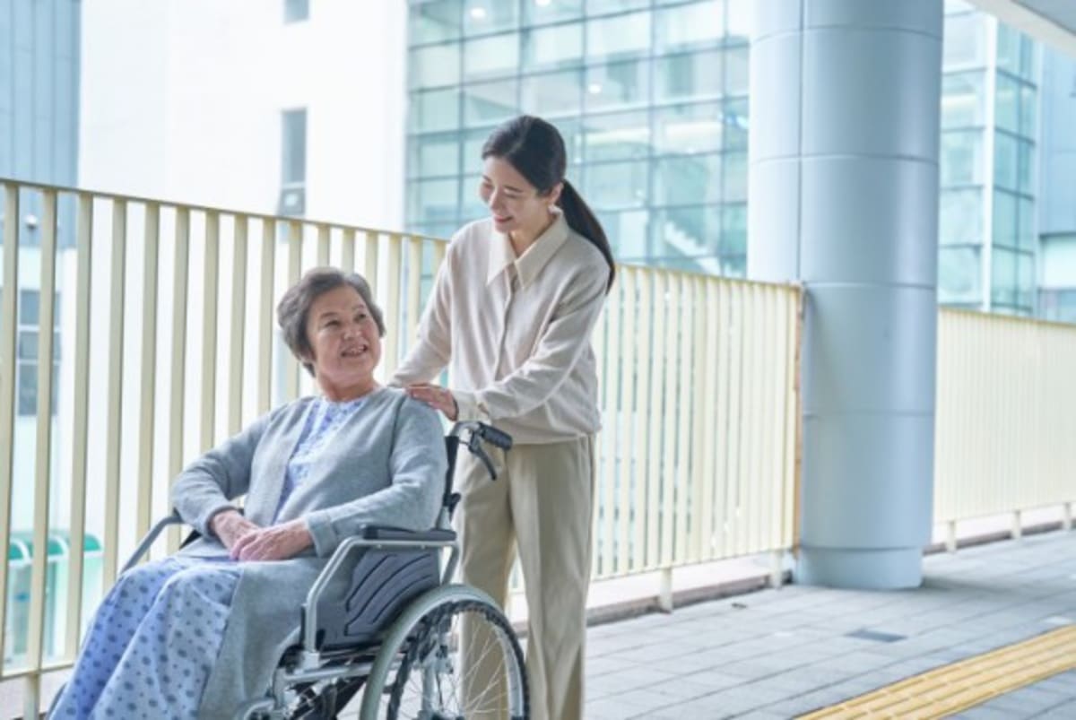 Elderly person at home with smart monitoring devices providing health and safety support