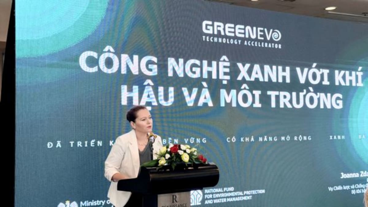 ** Vietnamese and Polish officials shaking hands at green technology cooperation signing ceremony