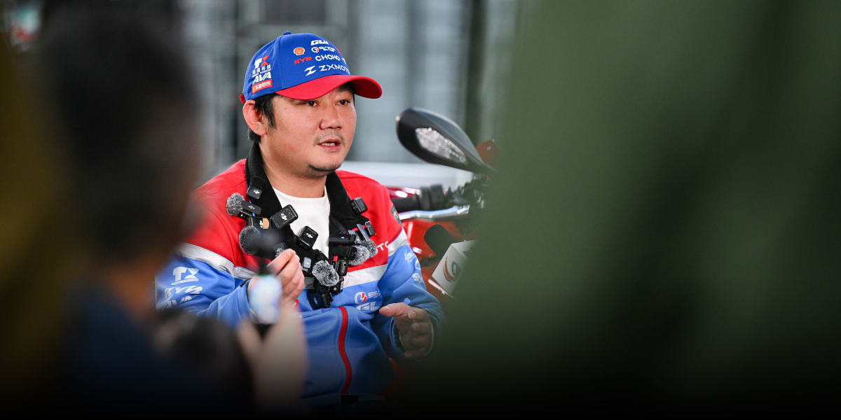Zhang Xue celebrates at motorcycle factory as rider wins world championship race
