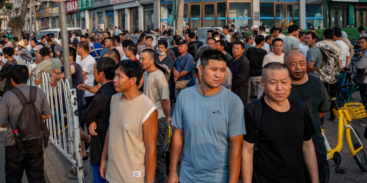 Day laborers gathering on a Beijing street corner waiting for work opportunities