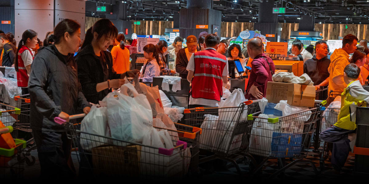 Customers shopping inside bright, well-stocked Pangdonglai supermarket in Henan province, China
