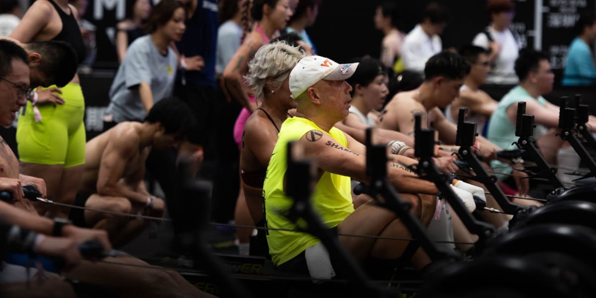 Elderly Chinese woman and adult daughter in athletic gear celebrating together at fitness race