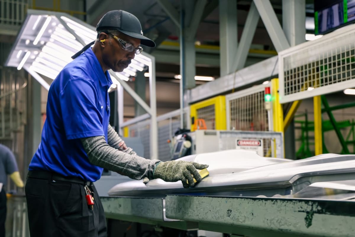 Assembly line workers at Kia's West Point Georgia plant building electric and hybrid vehicles