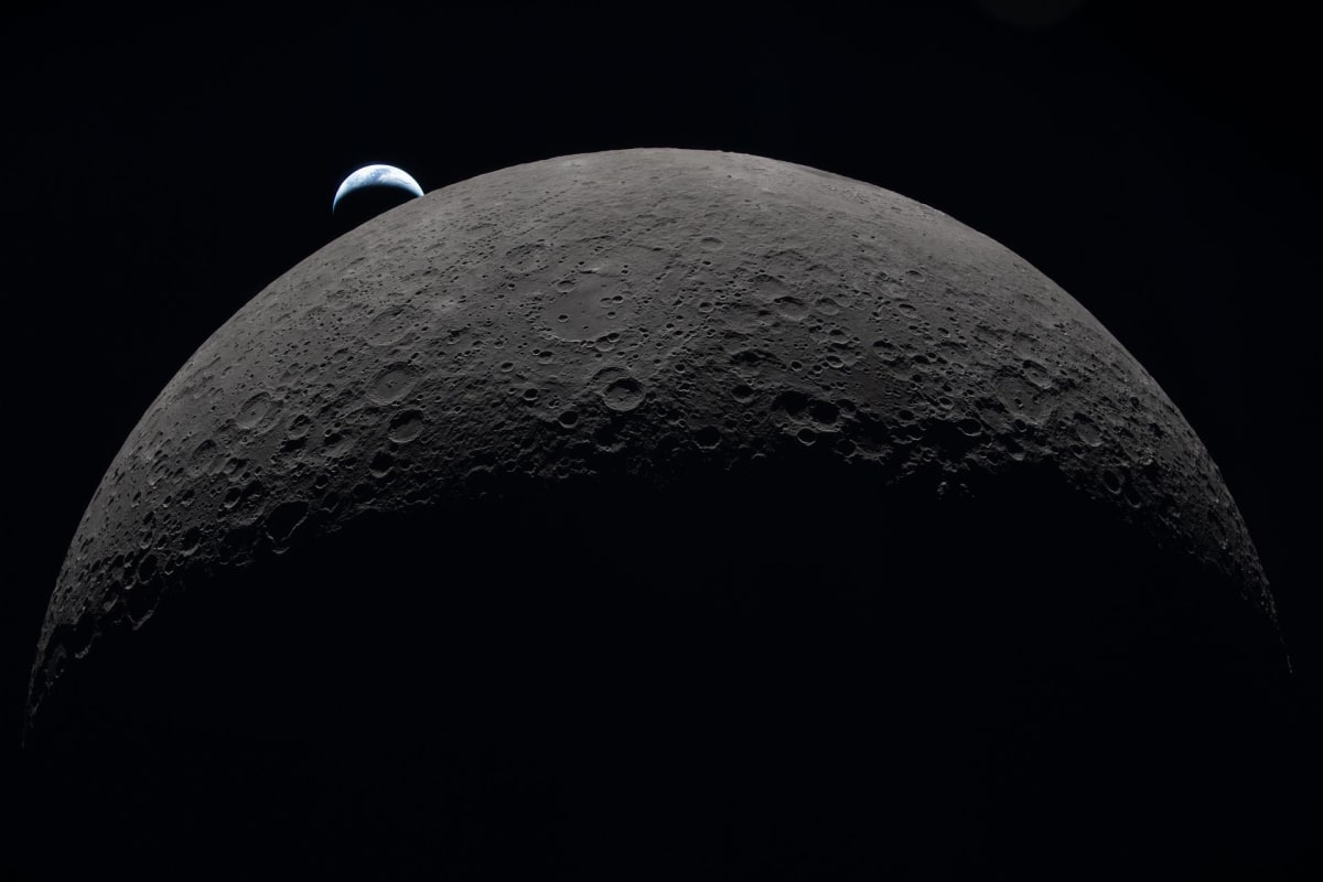 Earth rising over Moon's curved horizon during Artemis II mission orbit