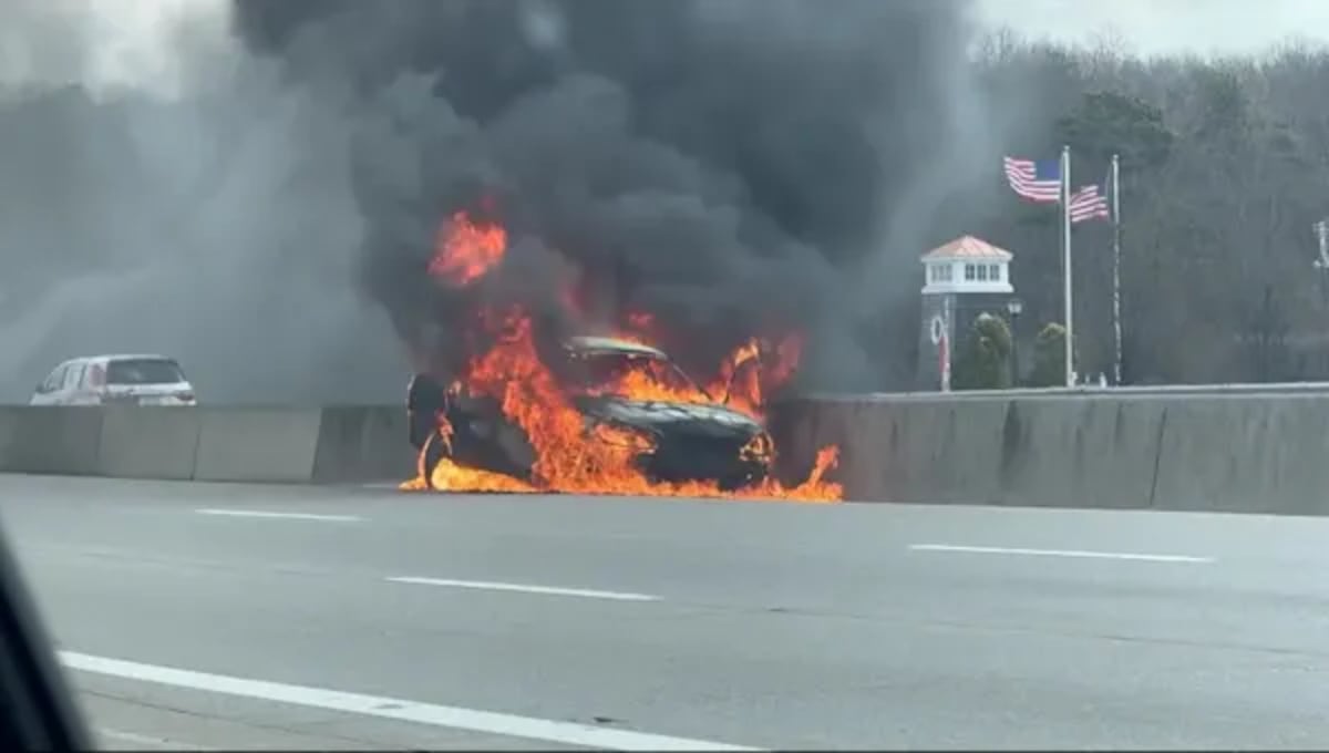 Firefighters extinguishing flames from car on Sunrise Highway after heroic rescue in Bohemia