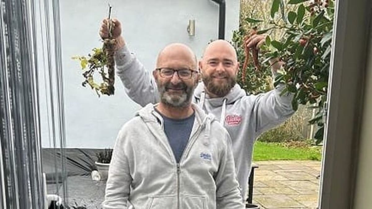 John Bailey and his son Jack smiling together, both wearing casual clothing, father showing recovery from brain surgery