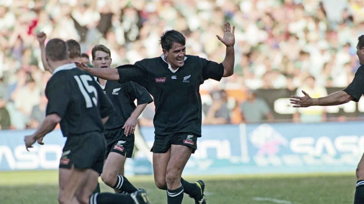 Zinzan Brooke in All Blacks jersey celebrating during historic rugby match action