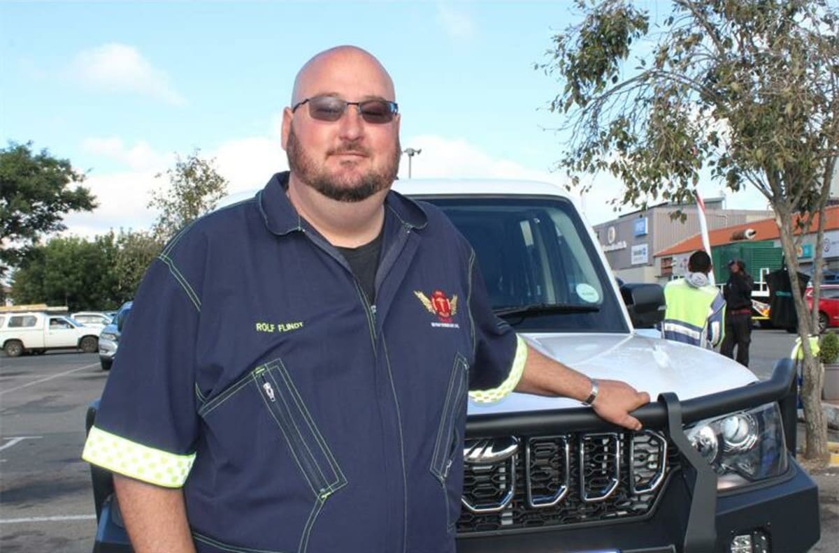 Rolf Flindt standing beside emergency response equipment seeking community donations for replacement gear