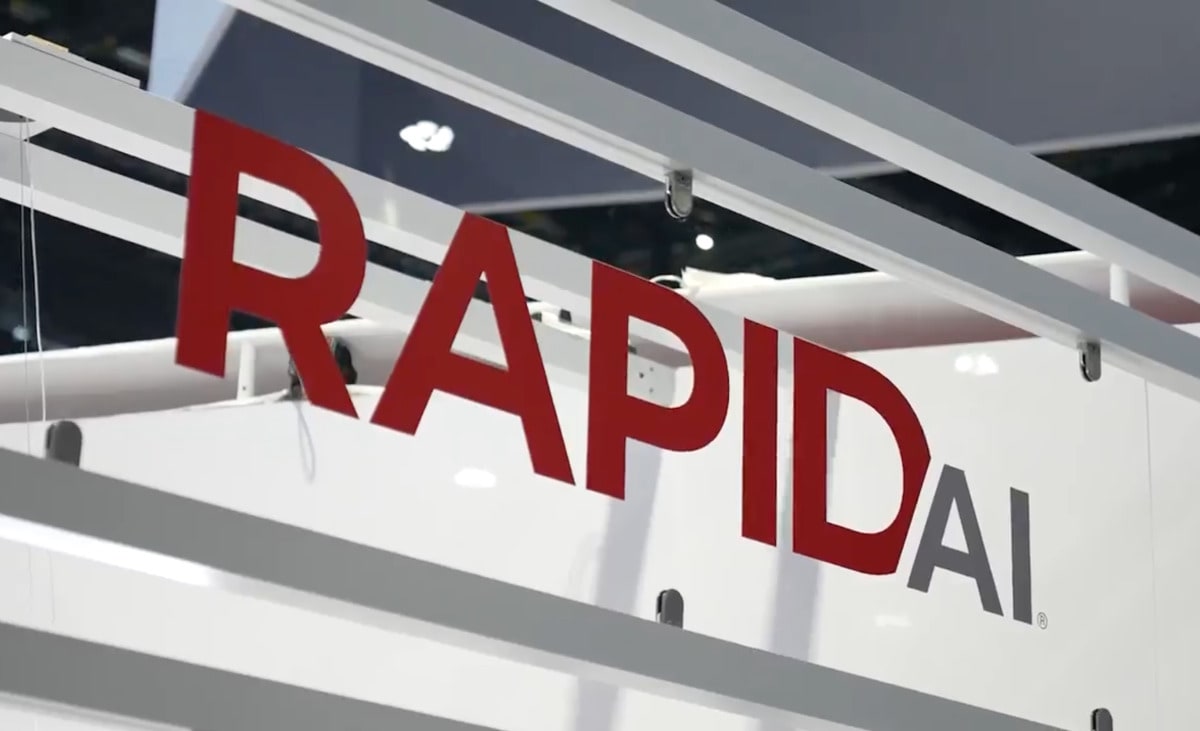 Medical professional reviewing three-dimensional brain scan images on computer monitor in hospital emergency department