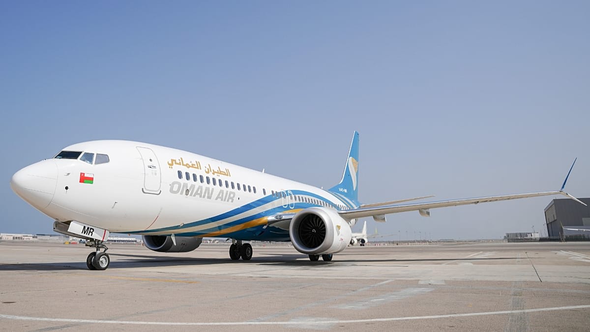 Oman Air aircraft at Muscat International Airport preparing for passenger boarding operations