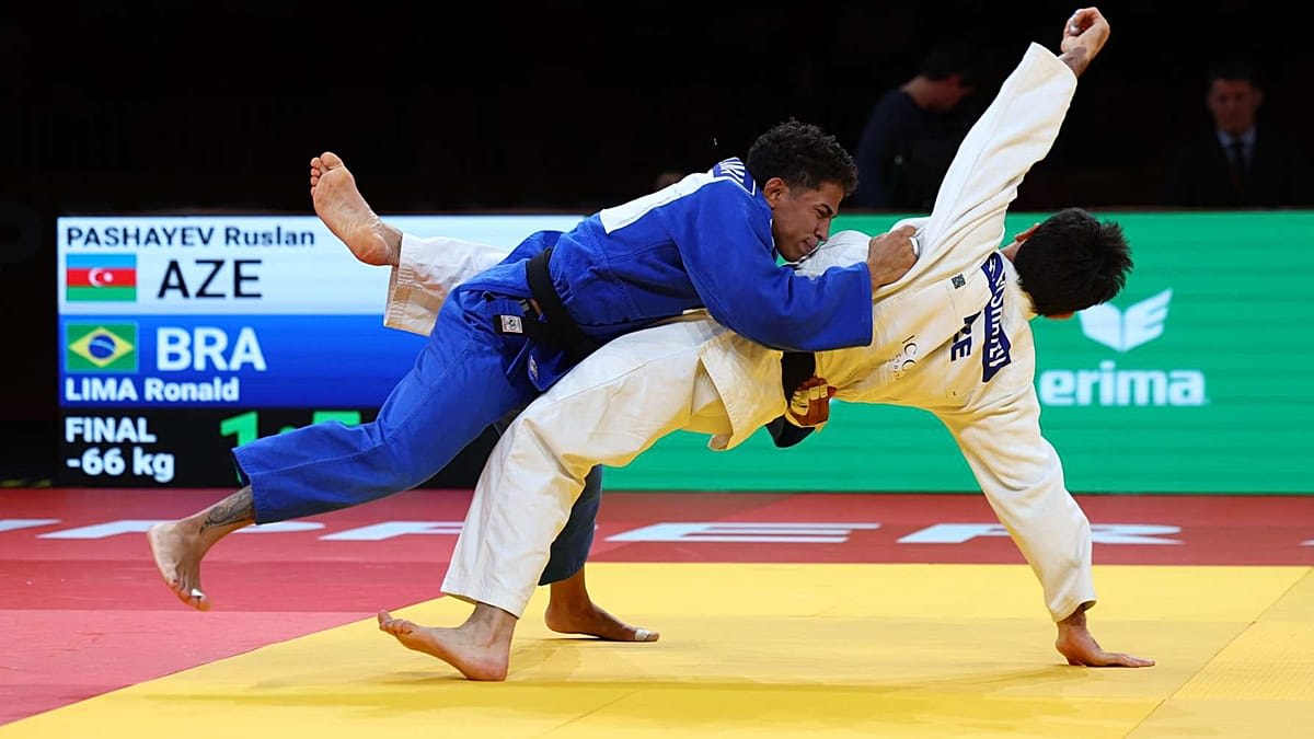 Judo competitors in white and blue gis engaged in dynamic throw at TipsArena Linz Austria