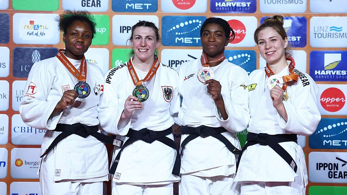 Austrian judoka Michaela Polleres celebrates gold medal victory with raised arms at home arena