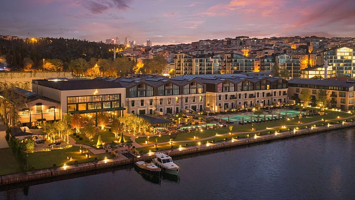 Panoramic view of Hotel Plesnik nestled in Slovenia's alpine glacial valley surrounded by mountains