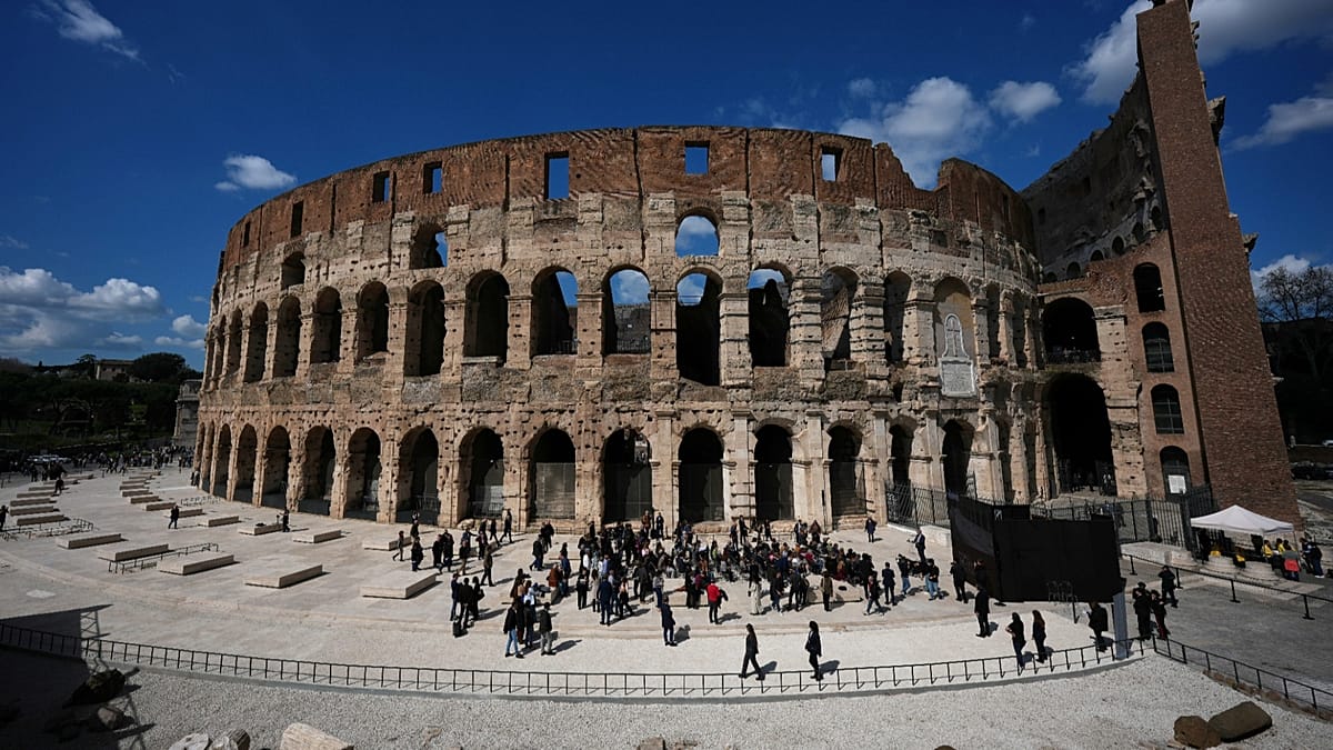 New travertine marble pavement surrounding Rome's Colosseum showing restored ancient entrance column positions