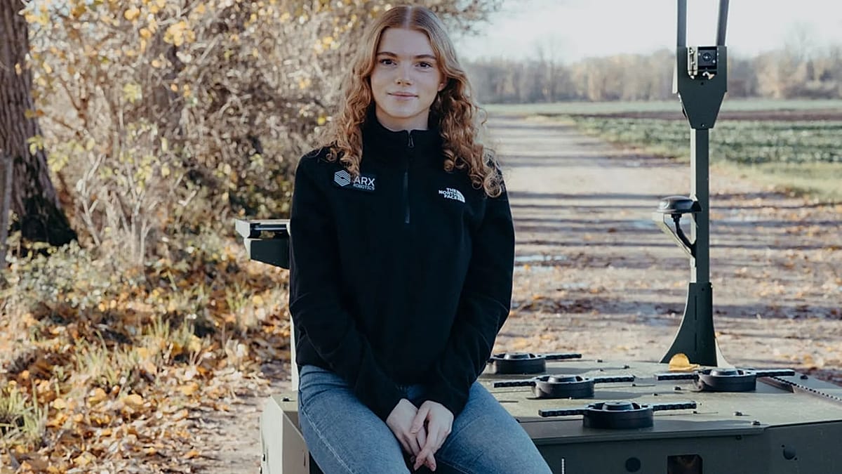 ** Young woman in professional setting working on autonomous robotics technology for European defense
