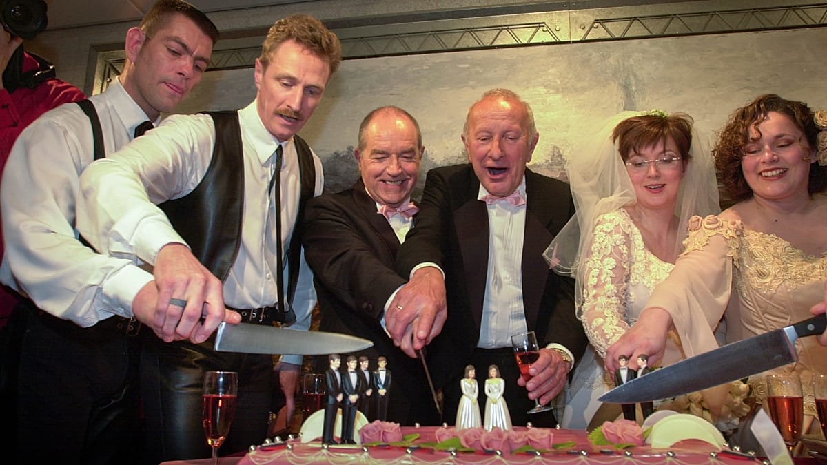 Mayor conducting same-sex wedding ceremony at Amsterdam City Hall during midnight anniversary celebration