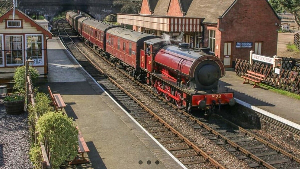 Vintage steam train with passengers dining on fish and chips in restored 1950s railway carriage