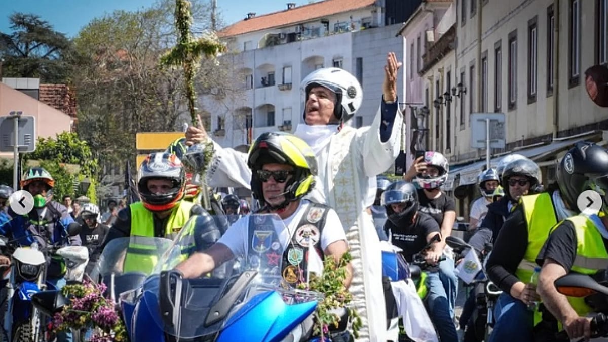 Portuguese priest on motorcycle leading hundreds of bikers carrying cross through Sintra streets