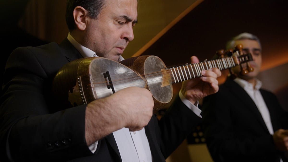 Azerbaijani musician performing traditional mugham or ashiq music with cultural instruments