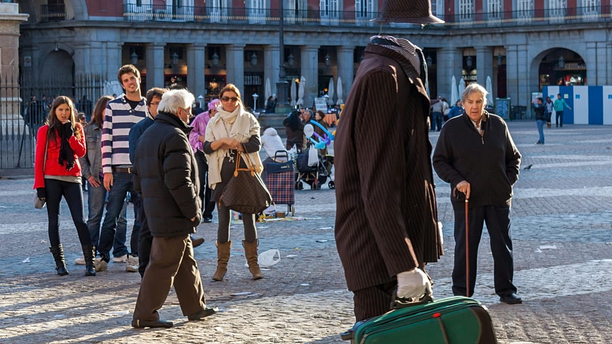 Tourists walking through historic Madrid street featured in popular films and television series
