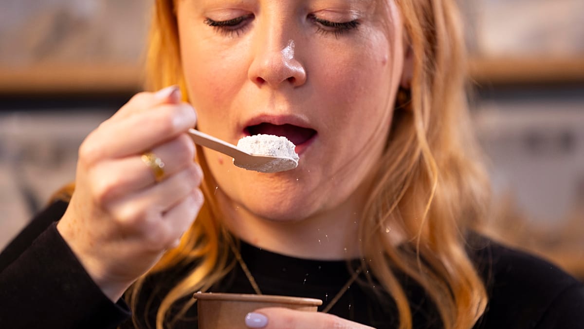 Hundreds of small glass jars containing soil samples from around the world displayed on shelves