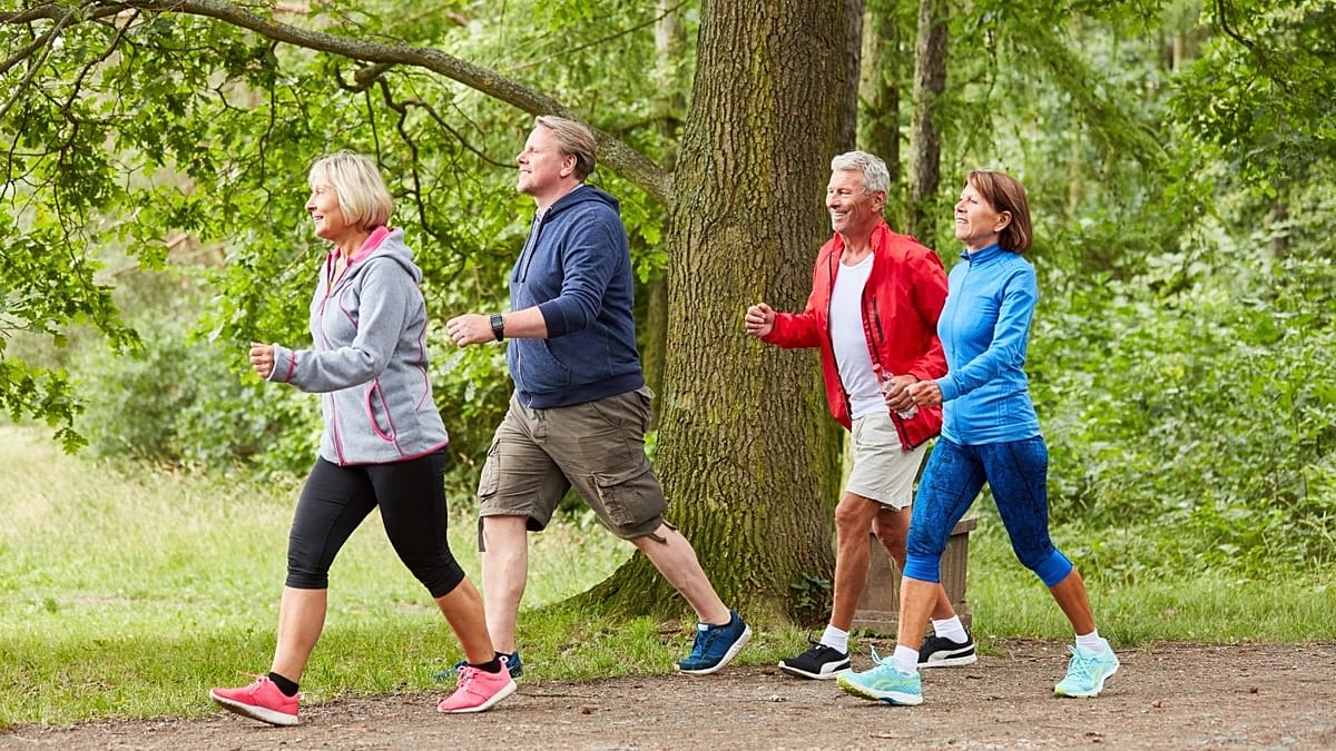Person walking outdoors tracking steps on fitness watch or smartphone device
