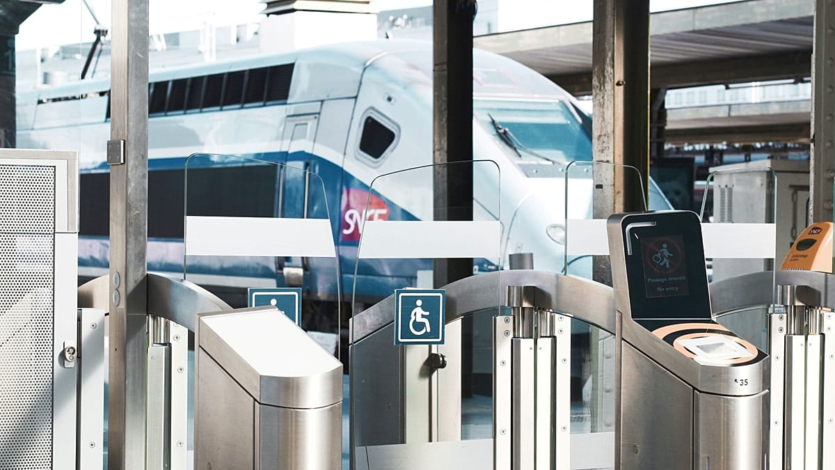 Modern high-speed passenger trains at European railway station platform connecting multiple countries