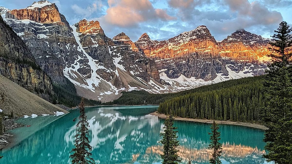 Scenic view of turquoise glacial lake surrounded by mountains in Canadian national park