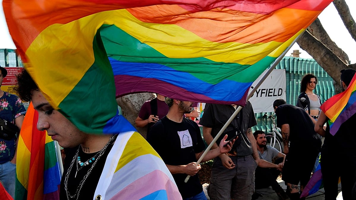 European Union flag waving with rainbow pride colors representing LGBTIQ+ rights protection across member states