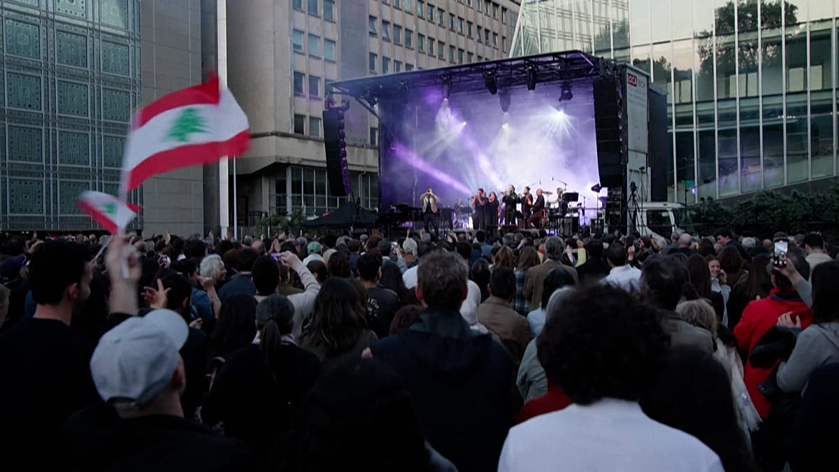 ** Musicians performing on outdoor stage at Paris Arab World Institute charity concert for Lebanon