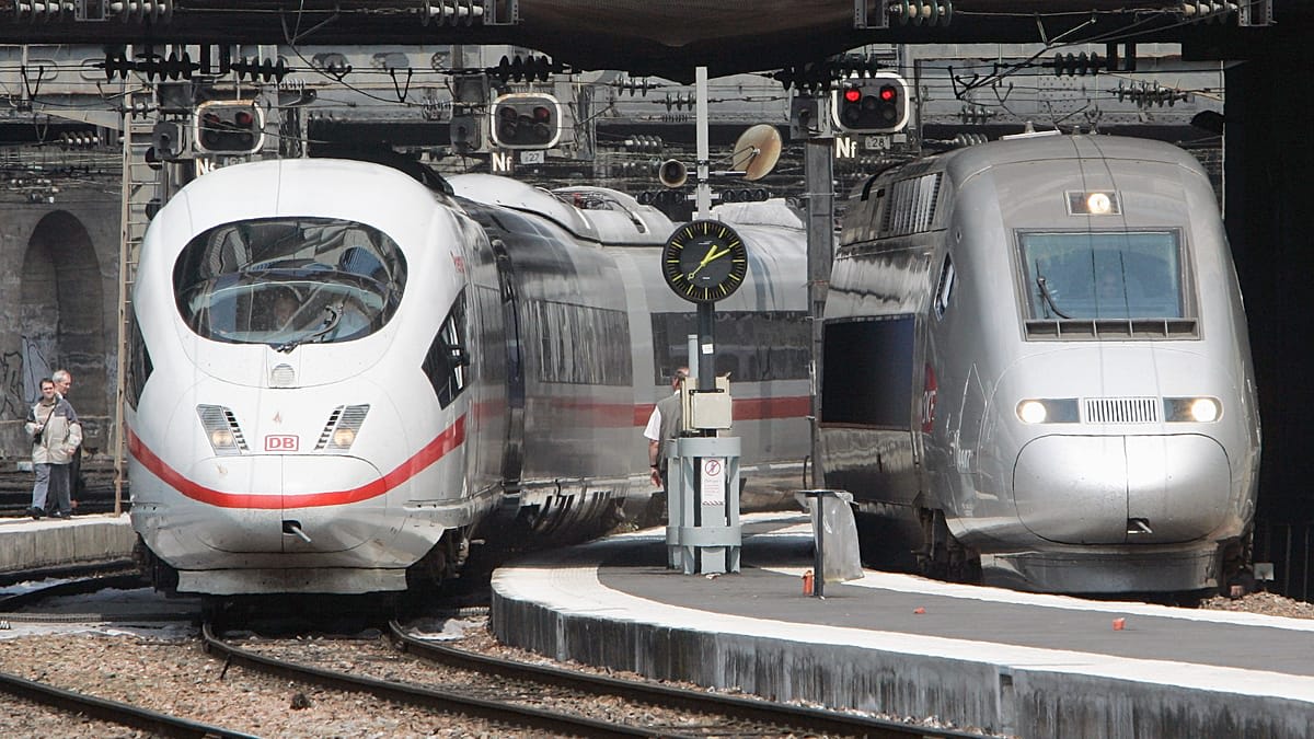 Modern European train at station platform with passengers boarding, symbolizing unified rail travel