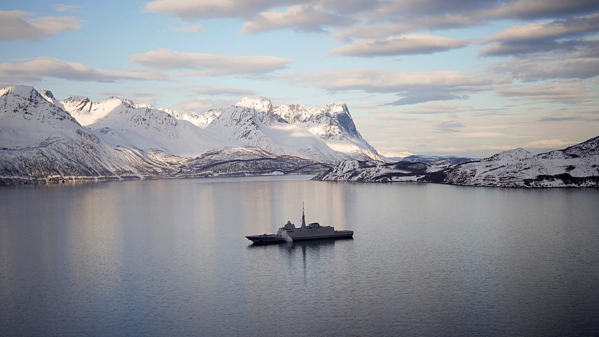 ** Wind turbines and solar panels against backdrop of pristine Arctic landscape with ice